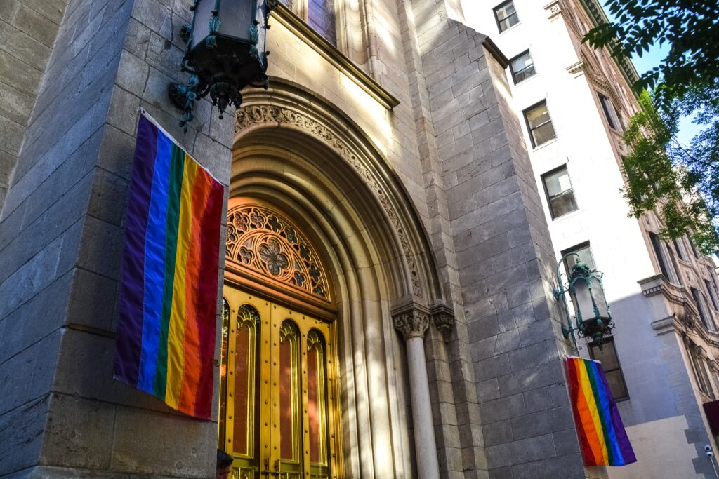 church doors with rainbow flags