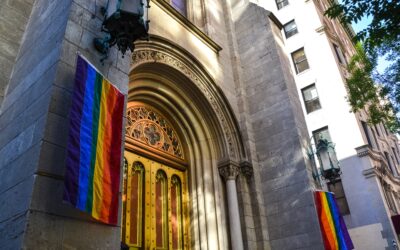 church doors with rainbow flags