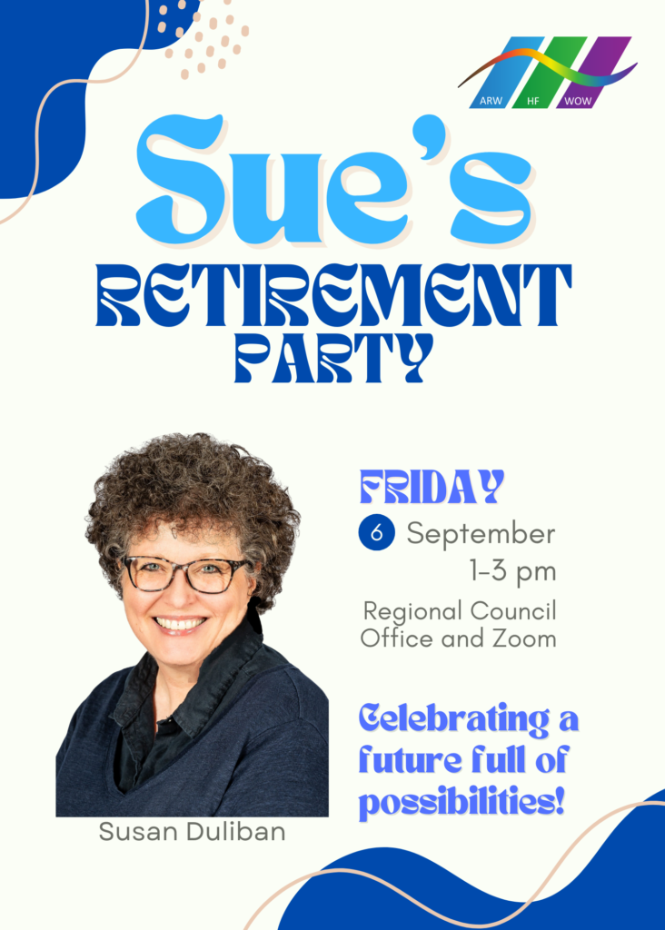 a woman with short brown curly hair wearing glass smiling and wearing a blue shirt and jacket her name is Sue