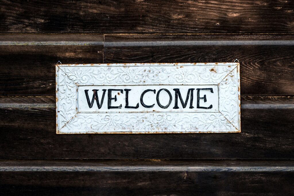 dark brown wood boards with a sign saying welcome